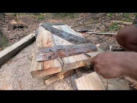 Secret dugout in the forest building a door from a fallen