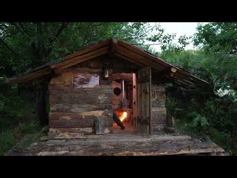 A man makes a window and shutters in his forest hut Solo