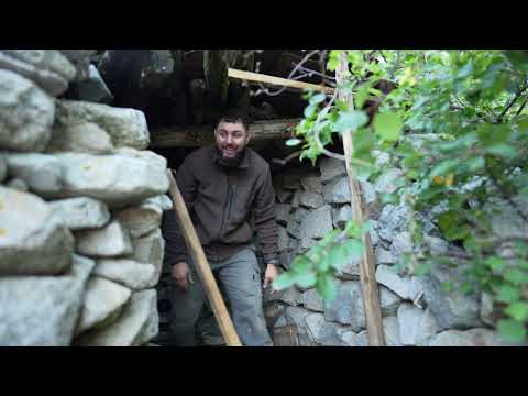 A man is restoring a stone house in the mountains Spends