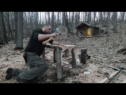 Building a log cabin in the forest a table made of dead